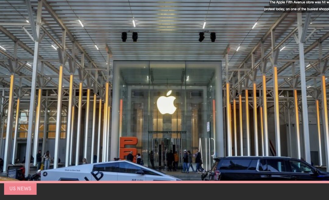 Demonstrators march outside Apples NYC Fifth Avenue retail store on Black Friday