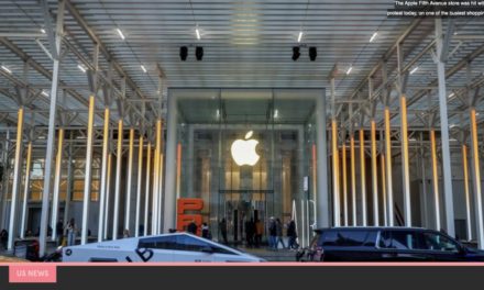 Demonstrators march outside Apples NYC Fifth Avenue retail store on Black Friday