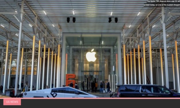Demonstrators march outside Apples NYC Fifth Avenue retail store on Black Friday